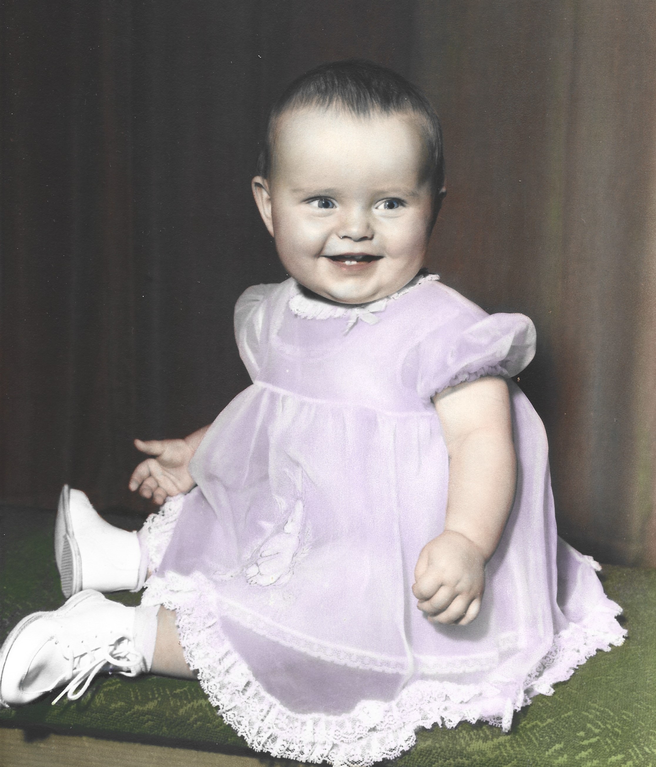 baby girl sitting up in a fancy dress