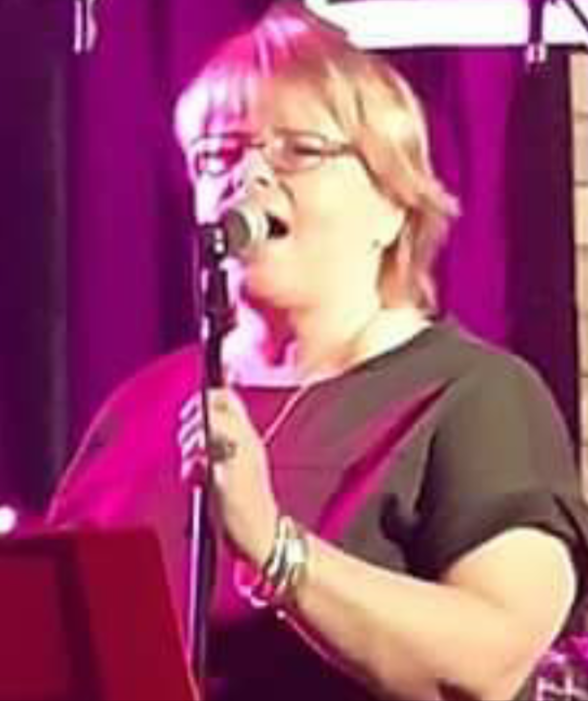 woman singing into a microphone