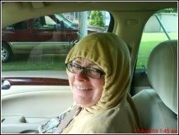 image of lady with tightly tied hood smiling at camera