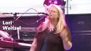 woman singing into a microphone